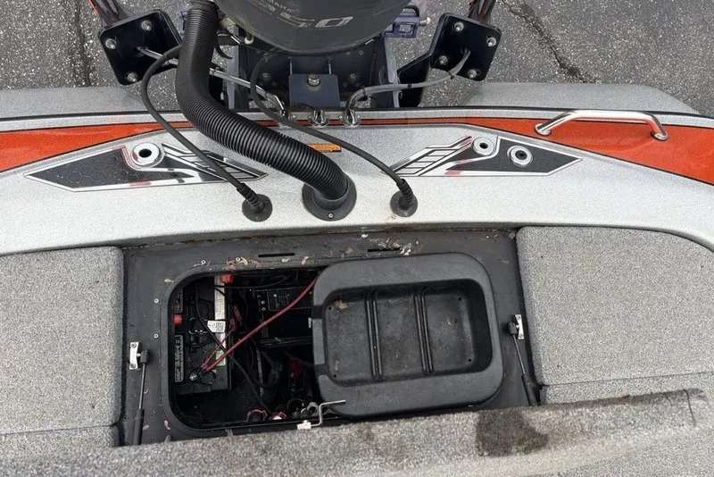 Slide: The Image of 2018 Skeeter FX21 boat battery compartment with wiring and engine components visible. - 37
