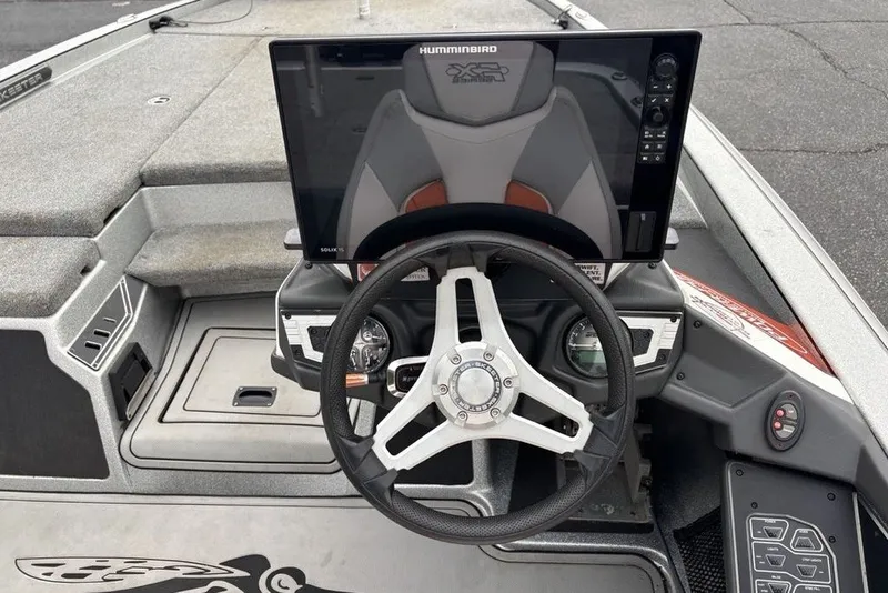 Slide: The Image of 2018 Skeeter FX21 boat dashboard with steering wheel and Humminbird display. - 15