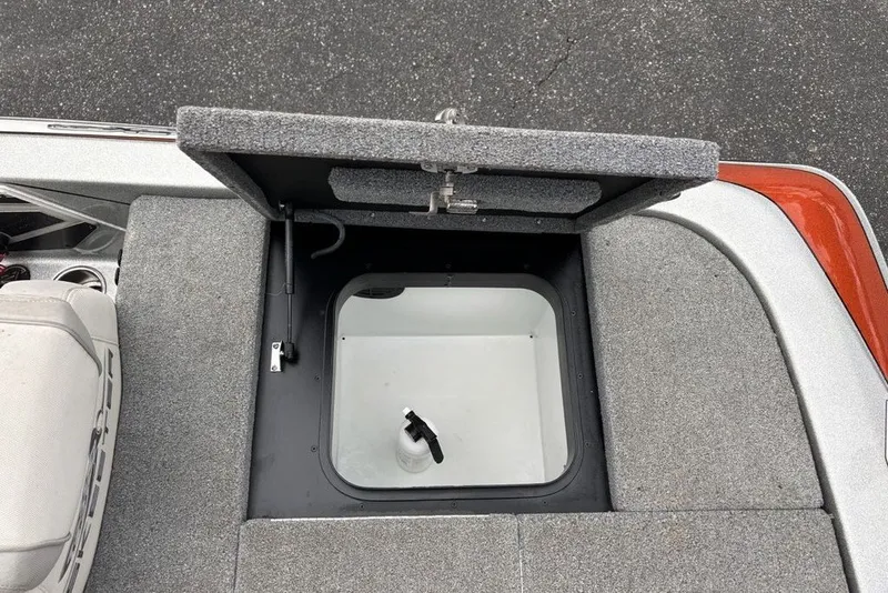 Slide: The Image of 2018 Skeeter FX21 boat storage compartment with open lid, showing interior details. - 28