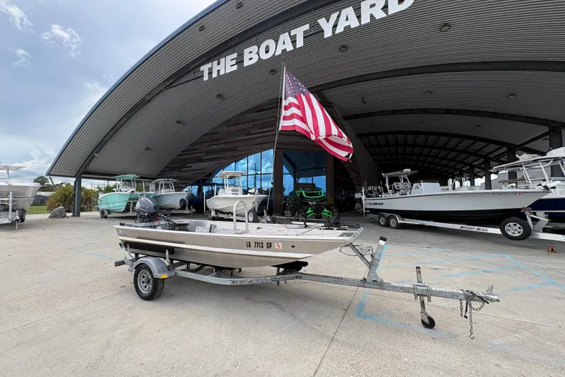 Slide: The Image of Custom 2023 model boat with American flag at The Boat Yard dealership. - 1