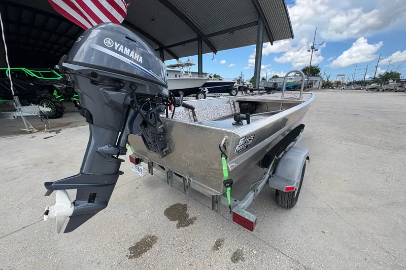 Slide: The Image of Aluminum boat with Yamaha outboard motor on trailer, under a canopy, 2023 model. - 3