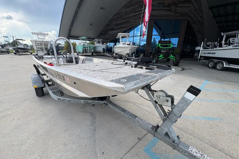Slide: The Image of Custom 2023 model boat on trailer outside a showroom with other boats. - 9