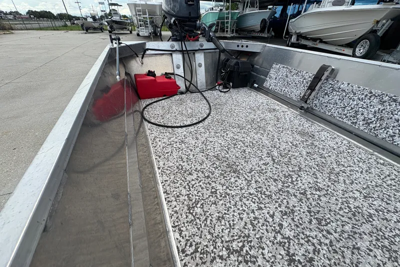 Slide: The Image of Interior of a 2023 Custom model 14 boat with speckled flooring and equipment. - 12