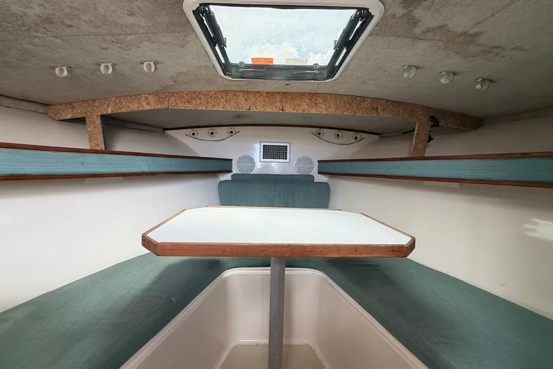 Slide: The Image of Interior cabin of a 2002 Carolina Classic 28 boat with seating and table. - 15