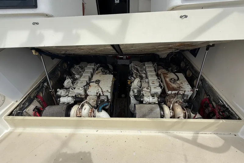 Slide: The Image of Engine compartment of a 2002 Carolina Classic 28 boat, showcasing dual engines. - 19