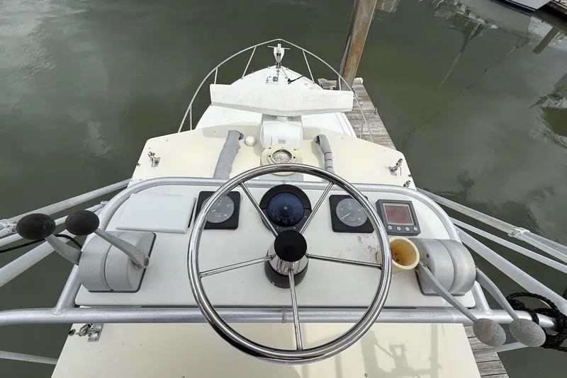 Slide: The Image of Helm of 2002 Carolina Classic 28 boat with steering wheel and controls. - 7