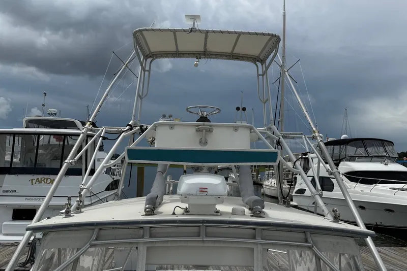 Slide: The Image of 2002 Carolina Classic 28 boat docked under cloudy skies. - 6