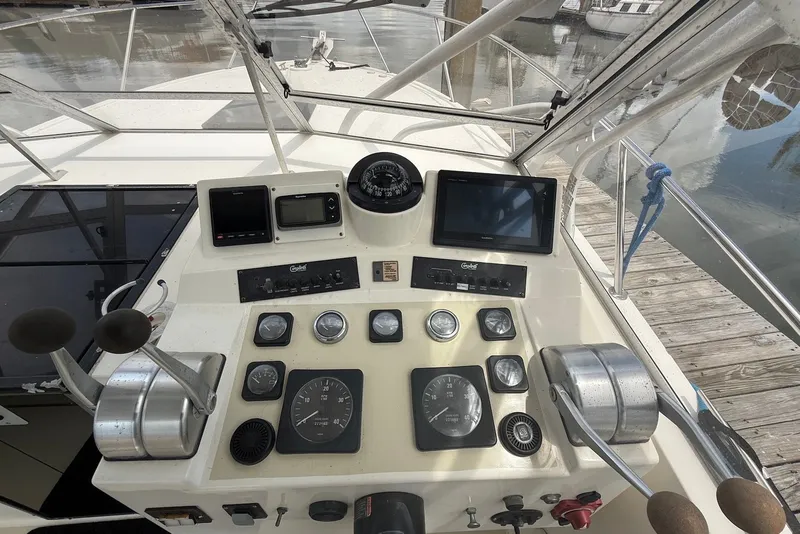 Slide: The Image of Helm of 2002 Carolina Classic 28 boat with navigation instruments and controls. - 9