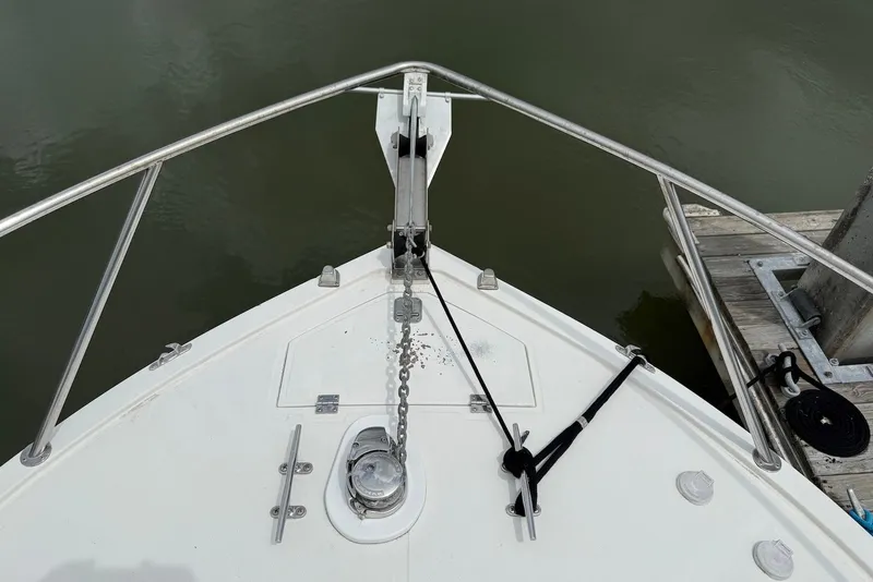 Slide: The Image of Bow of 2002 Carolina Classic 28 boat with anchor chain and dock view. - 5