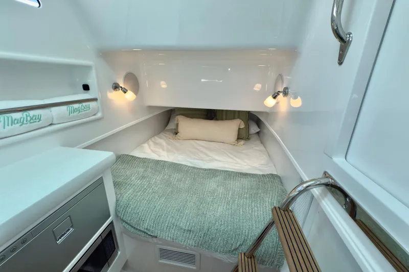 Slide: The Image of Manufacturer Provided Image: 2025 Mag Bay 38 CC cabin interior with cozy bed and modern lighting. - 5