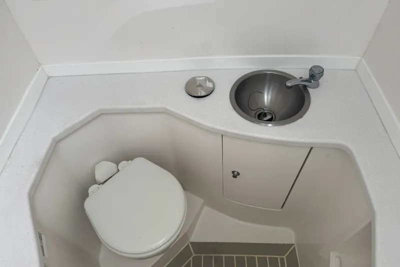 Slide: The Image of Compact bathroom in 2022 Intrepid 345 Nomad SE boat with sink and toilet. - 30
