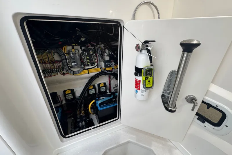 Slide: The Image of Electrical compartment of 2022 Intrepid 345 Nomad SE with fire extinguisher and wiring. - 32