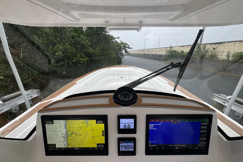 Slide: The Image of Cockpit view of 2022 Intrepid 345 Nomad SE with navigation screens and compass. - 9