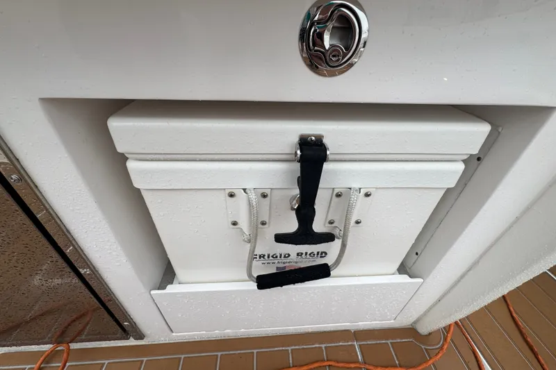 Slide: The Image of Built-in cooler on 2022 Intrepid 345 Nomad SE boat, featuring secure latch and sleek design. - 27