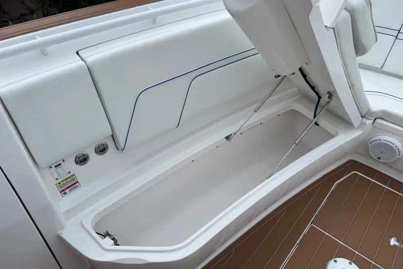 Slide: The Image of 2022 Intrepid 345 Nomad SE boat storage compartment with open hatch and seating. - 39