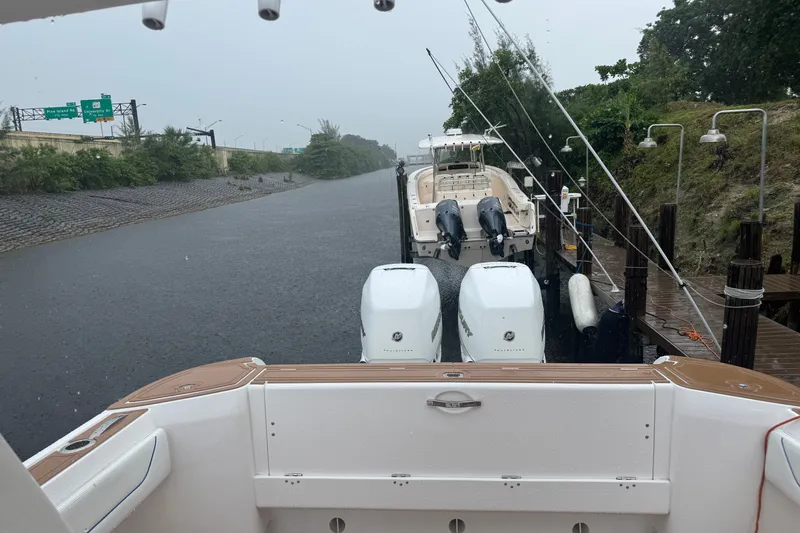 Slide: The Image of 2022 Intrepid 345 Nomad SE docked in a canal on a rainy day. - 43