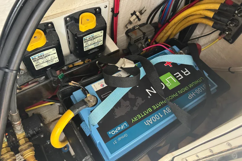 Slide: The Image of Battery compartment of a 2022 Intrepid 345 Nomad SE with lithium-ion battery and wiring. - 34