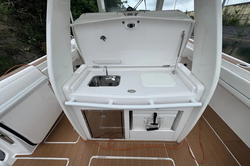 Slide: The Image of 2022 Intrepid 345 Nomad SE boat with onboard sink and storage area. - 25