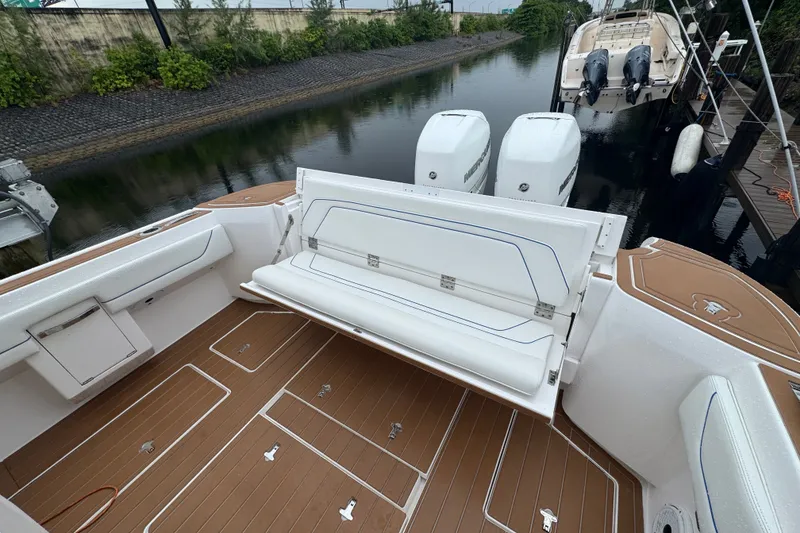 Slide: The Image of 2022 Intrepid 345 Nomad SE boat with foldable seating and twin Mercury engines. - 22