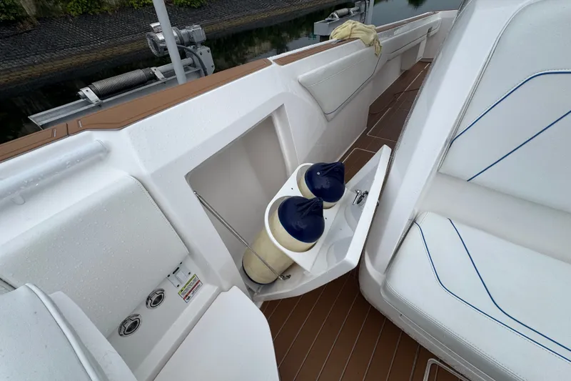 Slide: The Image of 2022 Intrepid 345 Nomad SE boat interior with storage compartment and fenders. - 37