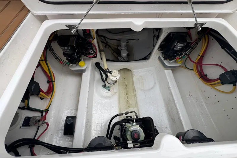 Slide: The Image of Engine compartment of a 2022 Intrepid 345 Nomad SE boat, showcasing wiring and components. - 36