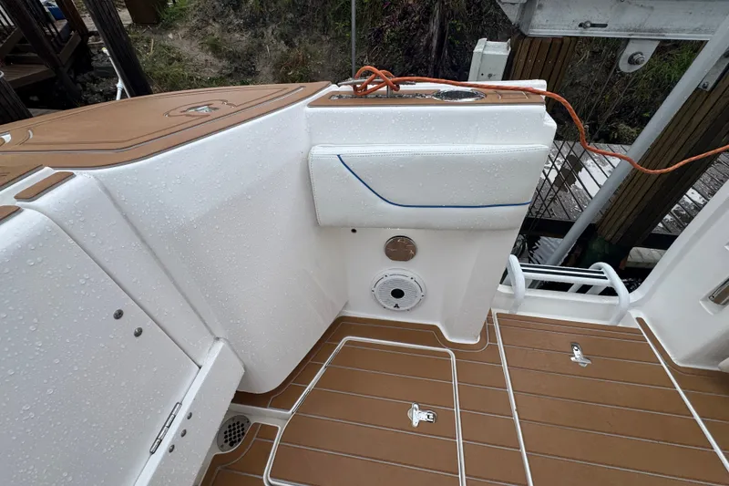 Slide: The Image of 2022 Intrepid 345 Nomad SE boat deck with wet surfaces and teak flooring. - 23