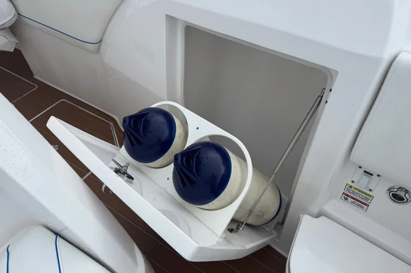 Slide: The Image of Storage compartment on 2022 Intrepid 345 Nomad SE boat with fenders inside. - 38