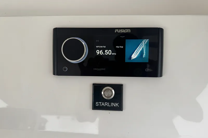 Slide: The Image of Fusion radio and Starlink button on 2022 Intrepid 345 Nomad SE boat dashboard. - 12
