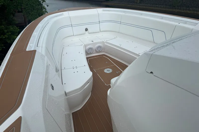 Slide: The Image of 2022 Intrepid 345 Nomad SE boat with spacious seating and sleek design. - 21