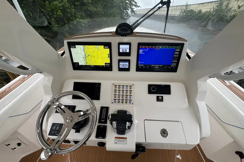 Slide: The Image of 2022 Intrepid 345 Nomad SE helm with advanced navigation displays and controls. - 8