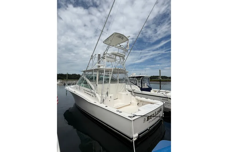 Slide: The Image of 2007 Cabo 32 Express boat docked under a partly cloudy sky. - 13