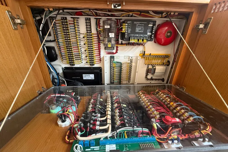 Slide: The Image of Electrical panel inside a 2007 Cabo 32 Express boat, showcasing wiring and components. - 71