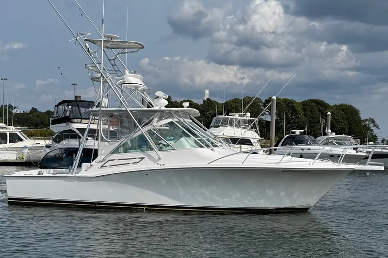 Slide: The Image of 2007 Cabo 32 Express boat docked in a marina under cloudy skies. - 9