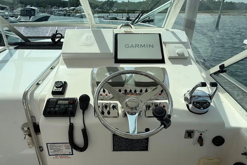 Slide: The Image of Helm of 2007 Cabo 32 Express boat with Garmin navigation system and controls. - 38