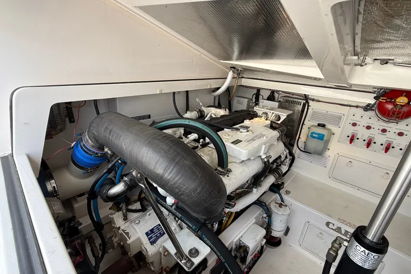Slide: The Image of Engine room of 2007 Cabo 32 Express boat, showcasing machinery and control panels. - 30