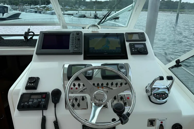 Slide: The Image of Helm of 2007 Cabo 32 Express boat with navigation equipment and steering wheel. - 39