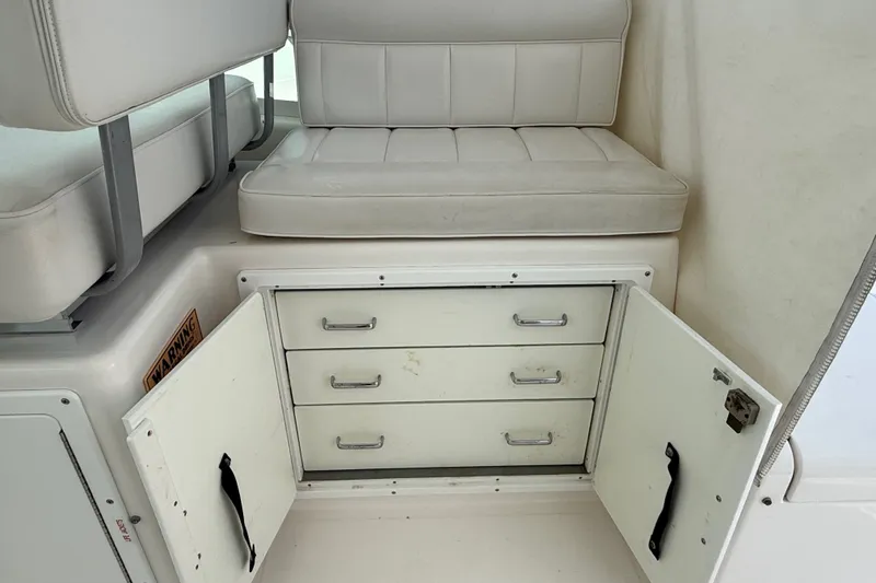 Slide: The Image of Interior of 2007 Cabo 32 Express boat with open storage drawers and cushioned seating. - 48