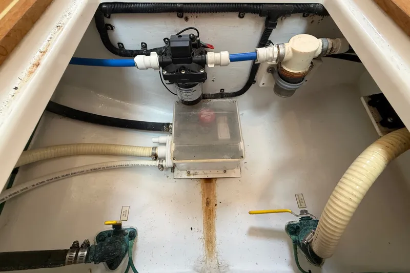 Slide: The Image of 2007 Cabo 32 Express boat plumbing system with hoses and valves. - 69