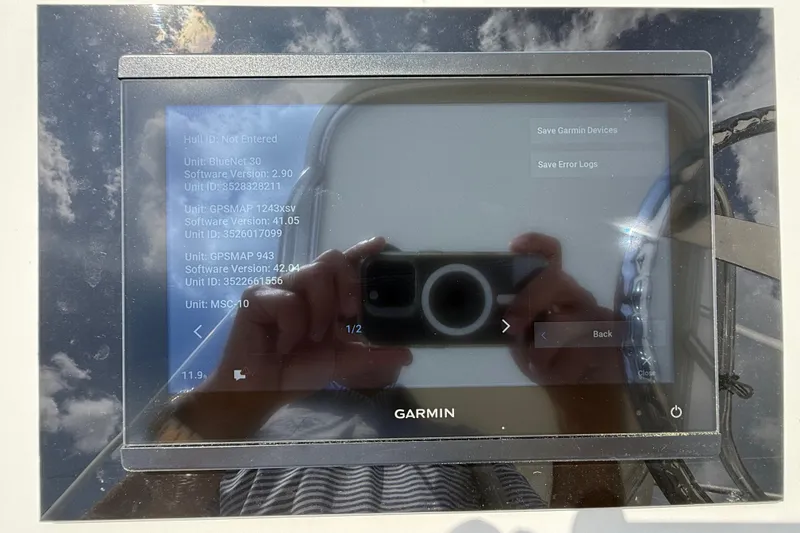 Slide: The Image of A Garmin navigation device on a boat with a reflective screen. - 54