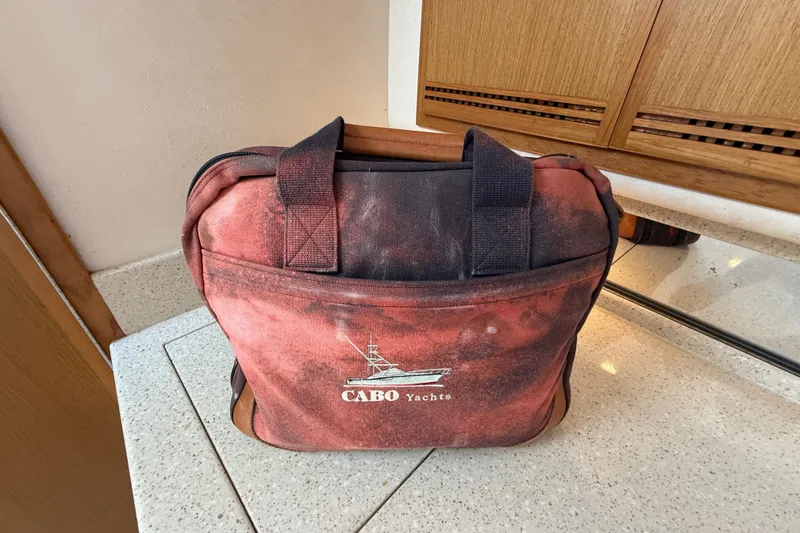 Slide: The Image of Red Cabo Yachts bag on a countertop, showcasing the 2007 Cabo 32 Express model. - 75