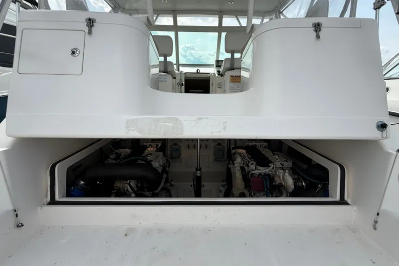 Slide: The Image of Engine compartment of a 2007 Cabo 32 Express boat, showcasing dual engines. - 28