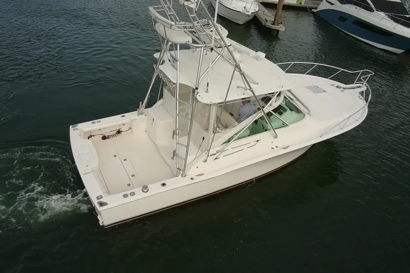 Slide: The Image of 2007 Cabo 32 Express boat navigating in a marina, viewed from above. - 3