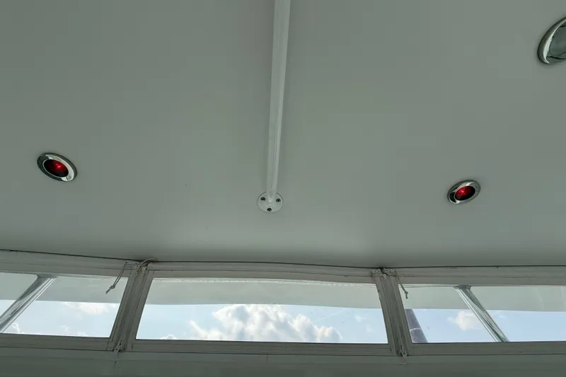 Slide: The Image of Ceiling view inside 2007 Cabo 32 Express boat, featuring red lights and windows. - 51