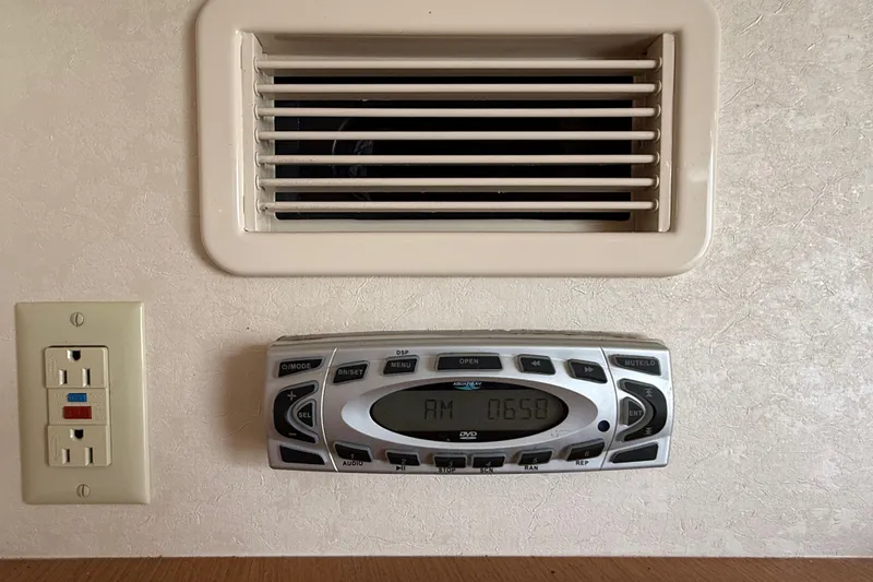 Slide: The Image of 2007 Cabo 32 Express interior with air vent, stereo system, and electrical outlet. - 74