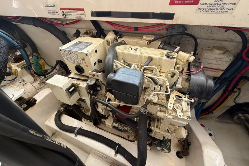 Slide: The Image of Engine compartment of a 2007 Cabo 32 Express boat, showcasing mechanical components and wiring. - 36