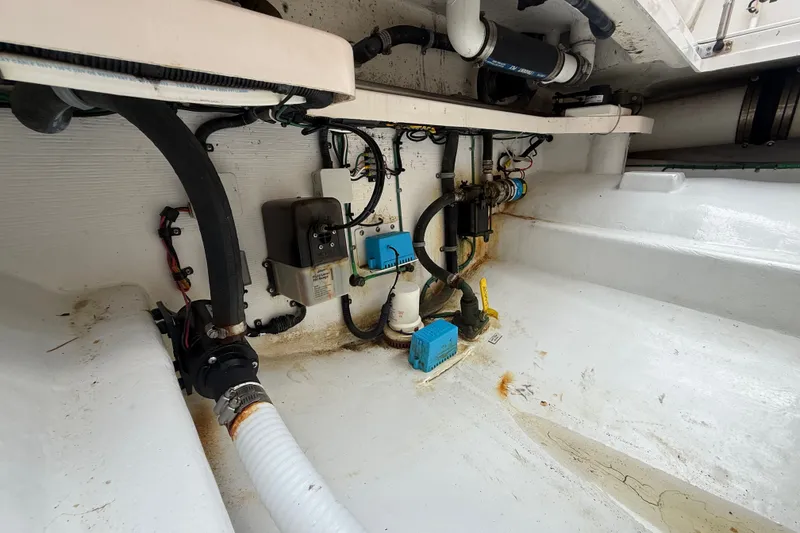 Slide: The Image of Engine compartment of a 2007 Cabo 32 Express boat, showing various mechanical components. - 24