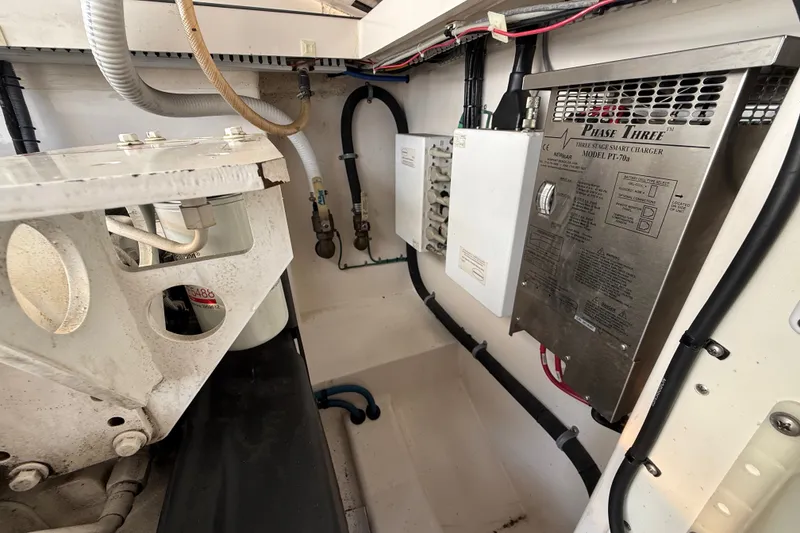 Slide: The Image of Engine compartment of a 2007 Cabo 32 Express boat, featuring electrical components and wiring. - 33