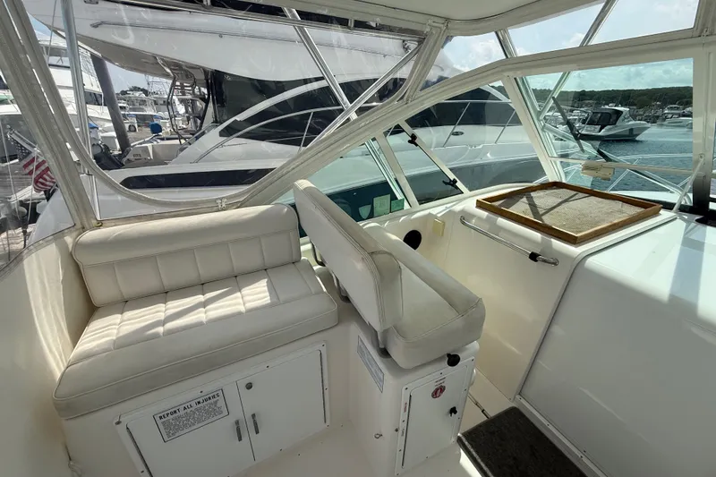 Slide: The Image of Interior of a 2007 Cabo 32 Express boat with white seating and dashboard. - 45