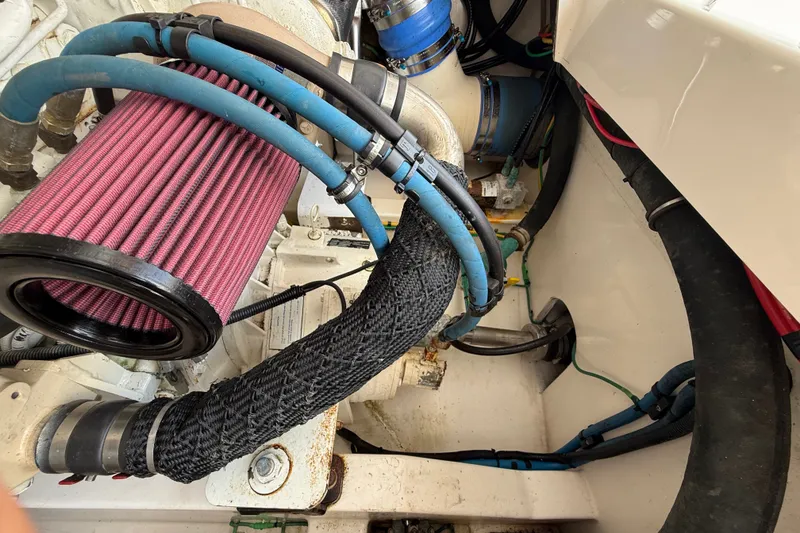 Slide: The Image of Engine compartment of a 2007 Cabo 32 Express boat with visible air filter and hoses. - 37