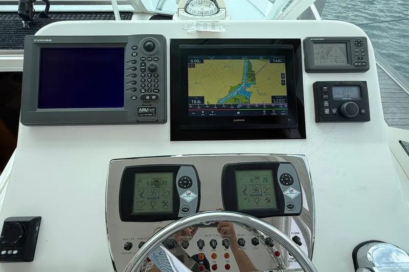 Slide: The Image of Control panel of a 2007 Cabo 32 Express boat with navigation screens. - 40